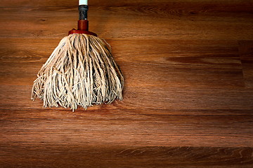 Image showing cleaning brown parquet with mop