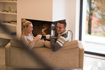 Image showing Young couple  in front of fireplace