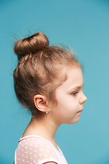 Image showing Cute little girl on a blue background close-up