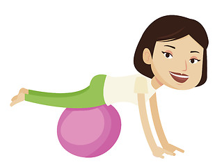 Image showing Young woman exercising with fitball.