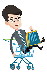 Image showing Happy man riding by shopping trolley.