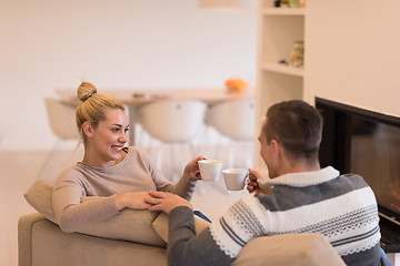 Image showing Young couple  in front of fireplace