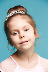 Image showing Cute little girl on a blue background close-up