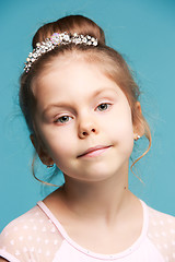 Image showing Cute little girl on a blue background close-up