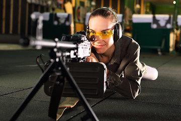 Image showing Shooting range. A woman with a machine gun.