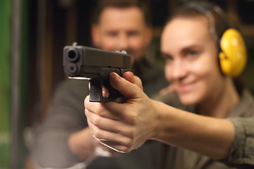 Image showing Glock, woman shoots at the shooting range