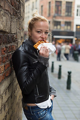Image showing Woman eating belgian waffle on street of Brussels.