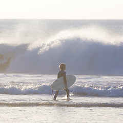 Image showing Surfers on beach with surfboard.