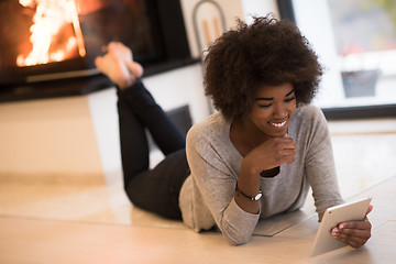 Image showing black women used tablet computer on the floor