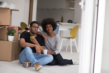 Image showing African American couple relaxing in new house