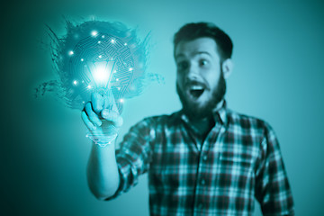 Image showing Handsome young man with idea bulb on blue