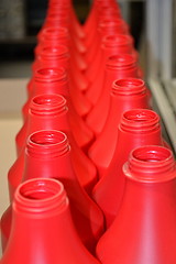 Image showing Red plastic bottles