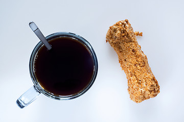 Image showing Coffee and eclair, top view