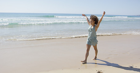 Image showing Female walking along the shore of beach