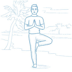 Image showing Man practicing yoga on the beach.