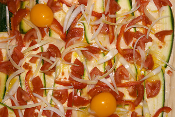 Image showing Close-up surface of a paprika, squash, onion and egg pizza