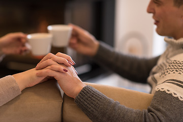 Image showing Young couple  in front of fireplace