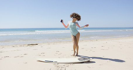 Image showing Female listening music and dancing on beach