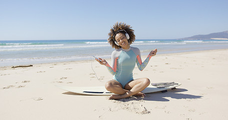 Image showing Female listening music on sea background