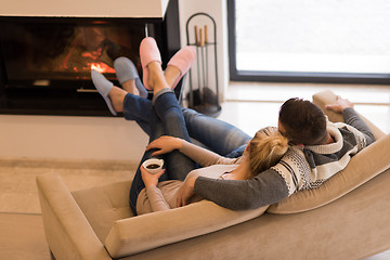 Image showing Young couple  in front of fireplace