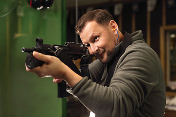 Image showing Military exercises on the firing range The soldier fires a rifle at the shooting range