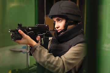 Image showing Woman in vest shot at the shooting range with a rifle