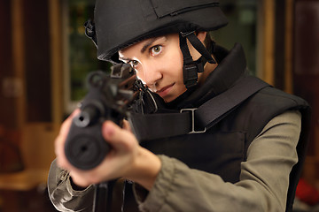 Image showing Woman shoots a rifle at the shooting range Policewoman at the shooting range with a rifle shot