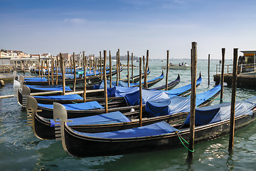 Image showing Gondolas moored in front of Saint Mark square in Venice