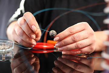 Image showing Create an amber necklace in a jewelery workshop