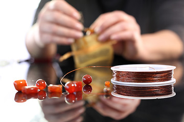 Image showing Amber set in silver, beautiful necklace. Workshop jewelery, working on an exclusive jewelry