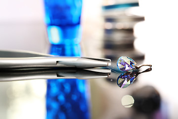 Image showing Jewelry, Swarovski crystal Woman hands a jeweler while working on jewelery