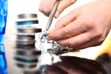 Image showing Jeweler, goldsmith while working on silver jewelry