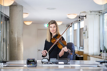 Image showing Classical Musician behind ticket counter