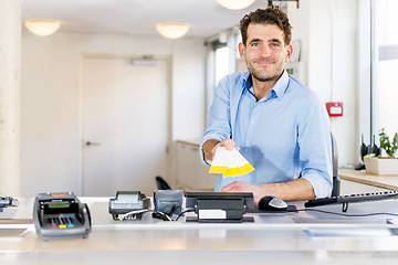 Image showing Friendly Ticket sales clerk