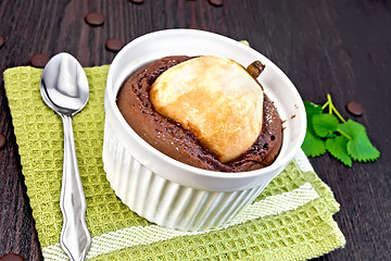 Image showing Cake chocolate with pear in white bowl on napkin