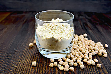 Image showing Flour chickpeas in glassful on dark board