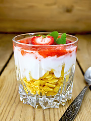 Image showing Dessert milk with strawberry in glassful on board