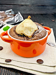 Image showing Cake chocolate with pear in red bowl on kitchen towel