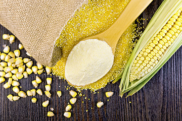 Image showing Flour corn in spoon with grains on dark board top