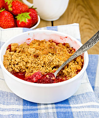 Image showing Crumble strawberry in white bowl on board