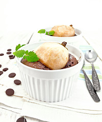 Image showing Cake chocolate with pear in white bowl on light board