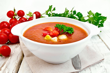 Image showing Soup tomato in white bowl with vegetables on towel