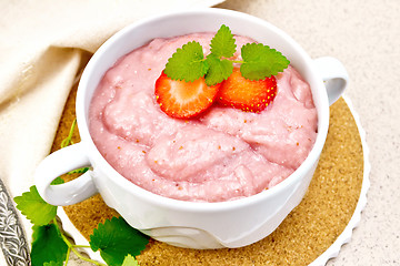 Image showing Soup strawberry in bowl with napkin on granite table