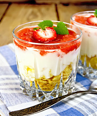 Image showing Dessert milk with strawberry in glassful on board and napkin