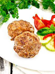 Image showing Cutlets stuffed with basil in white plate on board