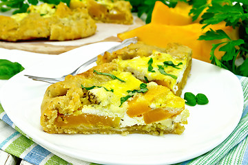 Image showing Pie of pumpkin and cheese in white plate on napkin