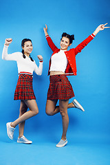 Image showing best friends teenage school girls together having fun, posing emotional on blue background, besties happy smiling, lifestyle people concept 