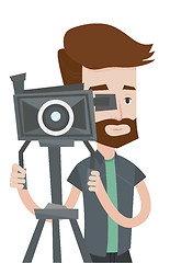 Image showing Cameraman with movie camera on tripod.