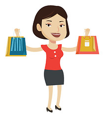 Image showing Happy woman holding shopping bags.