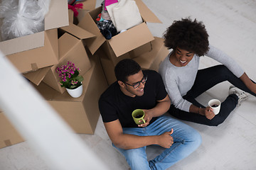 Image showing African American couple relaxing in new house